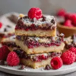 Chocolate raspberry bars on wooden board