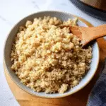 Fluffy instant pot quinoa in bowl with wooden spoon