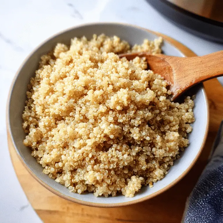 Fluffy instant pot quinoa in bowl with wooden spoon