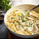 One Pot Chicken Alfredo Pasta in creamy sauce with parsley garnish